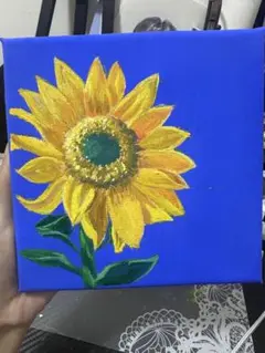青い背景のひまわりの油絵