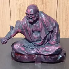 赤紫色の老僧の金属製の彫刻のサムネイル