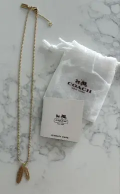 COACH フェザーモチーフ ネックレス ゴールドカラー