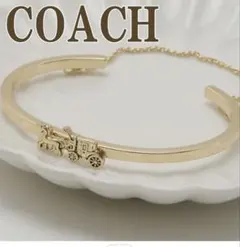 COACH ゴールドバングル 馬車モチーフ