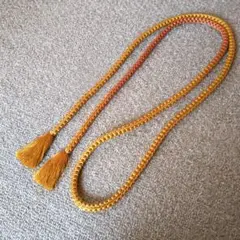 黄土色と薄い赤茶の房飾り付き帯締め