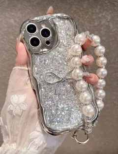 【iPhone17】グリッター&リボンデザインケース、パールビーズストラップ付き