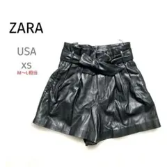 ザラ　黒ブラックフェイクレザーショーパンリボンUSAxs M〜L相当JKY2K