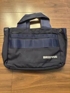 美品】BRIEFING ラウンドバッグ ネイビー - メルカリ