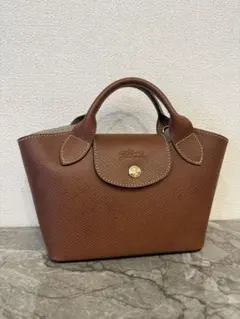 公式完売カラー！新品未使用LONGCHAMP エピュレXSブラウン - メルカリ