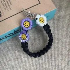 パラコード　ハンドスマホストラップ　☺︎ニコちゃん☺︎ お花　ハンドメイド
