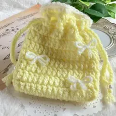 ハンドメイド かぎ針編み 巾着袋　ポーチ ホワイトリボン　イエロー　ゆめかわ