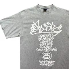 [L]ステューシーstussyワールドツアー90sレア希少Tシャツグレー紺タグ