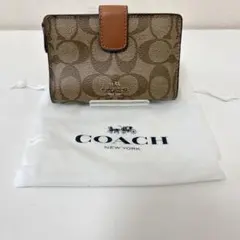 COACH 二つ折り財布 シグネチャー柄