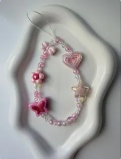 ハートと蝶々モチーフのピンク系ストラップ