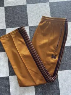 2026年最新】needles トラックパンツ マスタードの人気アイテム - メルカリ