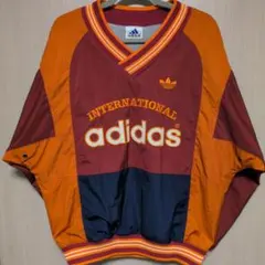 adidas アディダス 万国旗タグ 刺繍ロゴ ナイロンプルオーバー 常田大