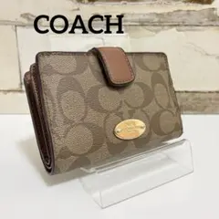 COACH 二つ折り財布 シグネチャー柄 ブラウン系