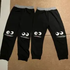目のデザイン付き黒パンツ 100、110