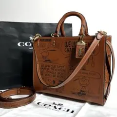 【未使用に近い】COACH X PEANUTS ローグ ニュースペーパープリント