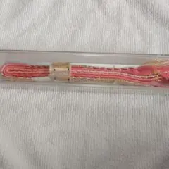 伝統的なピンクの帯締め（金糸入り）