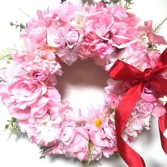 ふわふわピンクの造花リース 赤いリボン付きフラワーリース玄関リースプレゼント