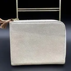 【未使用品】POMATATA 二つ折り財布 シャンパンゴールド タッセル付きのサムネイル