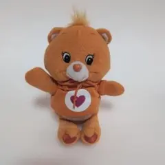 オレンジ色のフード付ケアベアぬいぐるみ