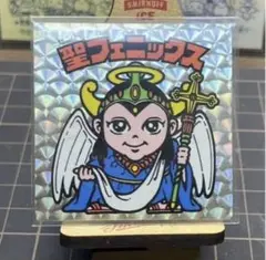 ビックリマンシール 聖フェニックス幼少四角プリズム - メルカリ