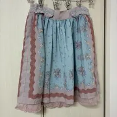 axes femme 鳥かごと花の総柄スカート