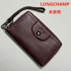 未使用LONGCHAMP レザーラウンドジップ財布　ボルドー ストラップ付きのサムネイル