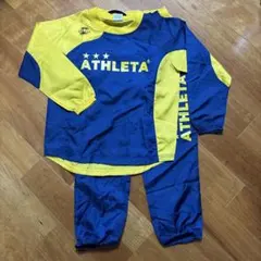 ATHLETA ピステ・ウィンドブレーカー 青/黄