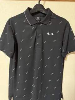 【美品】 OAKLEY ポロシャツ ブラック 総柄 US S JPN Mのサムネイル