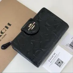 COACH ブラック折り財布 エンボス加工　黒色　二つ折り財布　美品