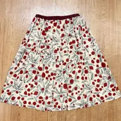 ホコモモラ ひざ丈 プリーツスカート 総柄 さくらんぼ ベージュ×レッド Lのサムネイル