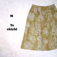 テチチ　ひざ丈フレアスカート　黄土色に白の花柄のイラスト　軽い　M