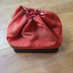オレンジの巾着型和装用バッグ