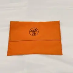 HERMESオレンジ色の巾着袋 Hのロゴ付き