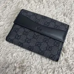 GUCCI GGキャンバス財布 黒 レザー フラップ　未使用