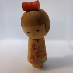 伝統的な木製こけし 赤いリボン付き