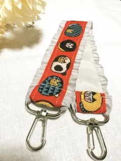 猫柄　フリル付き　刺繍リボン　スマホストラップ　オレンジ×グレー