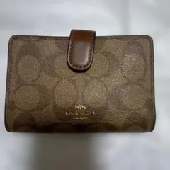 COACH 二つ折り財布 シグネチャー柄