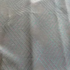 幾何学模様 グレーに青緑の刺繍柄の生地
