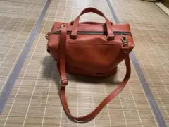 ハンドバッグ（オレンジ牛皮製）取外しストラップ付き