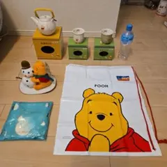 Not for sale: Winnie the Pooh teapot, teacups, cloth, bag, and figurine.
