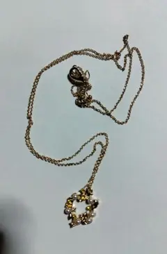 黄色い(黄緑にも見える)石とパールのようなものが付いているネックレス