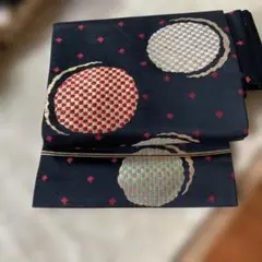 アンテイーク名古屋帯 黒地 赤金 円形模様