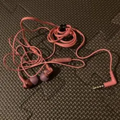 Pink wired earphones with volume control buttons and a selfie stick