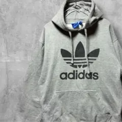 アディダストレフォイル ビッグロゴ スウェット パーカー グレー adidas