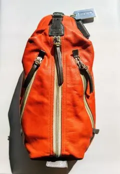 COACH／コーチ　中古品　トンプソンレザースリングバッグ　オレンジ