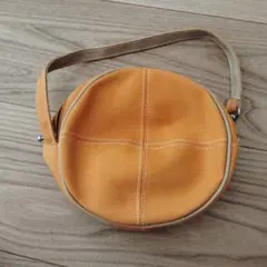 オレンジ 円形バッグ