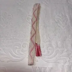 クリーム色と濃いピンクの編み込み帯締め