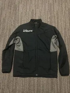 中綿ATHLETA ピステ・ウィンドブレーカー S 黒/グレー