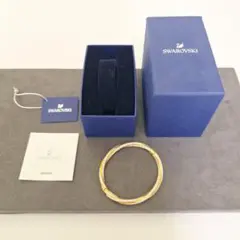 美品】SWAROVSKI ツイストバングル ゴールドカラー(sw11) - メルカリ