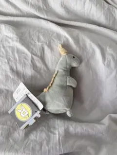 グレーの恐竜ぬいぐるみ Rロゴ付き